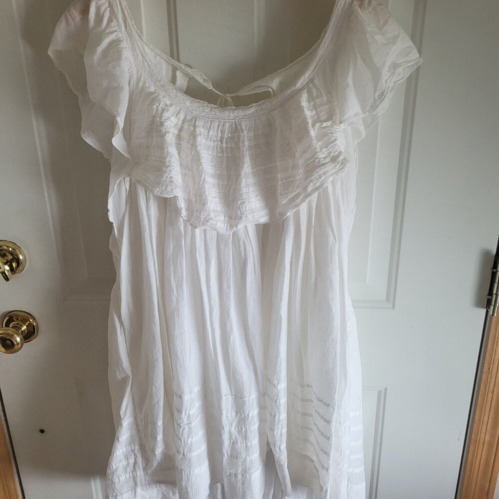 Free People white ivory mini dress with flutter sleeves.  Lined with open back.
